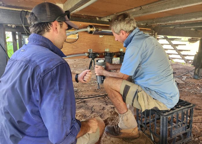 As a first priority, electricity and water facilities were restored to four houses and a main workshop that were spared from the floods. Ruben Lyons and Peter Dunn are pictured installing new UV filtration systems on the remaining liveable houses.