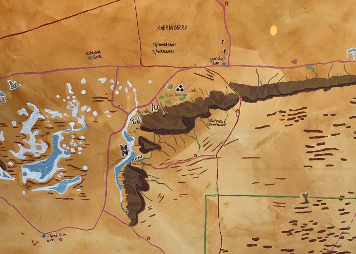 The map features icons for landscape features, wildlife and tjukurrpa (Dreaming) stories and significant sites. It will be used as the focal point in meetings and during activity planning.