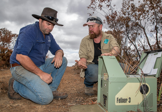 Pat (right) with Land Management Officer Murray Schofield and a felixer unit. These devices were deployed at Kangaroo Island after the fires to combat the impact of feral cats on displaced wildlife